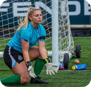 Goalkeeper sitting in a position to catch the ball