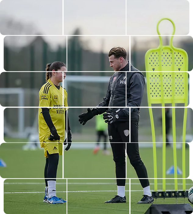 Arsenal Women's goalkeeper in yellow kit receiving coaching instructions during a training session