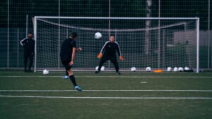 goalkeeper is in position, focused on a player taking a shot on goal